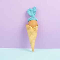 Cute easter bunny or rabbit with an egg face in an ice cream cone, spring holiday, greeting card