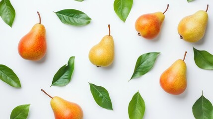Obraz premium Variety of ripe pears and green leaves arranged on a white surface for culinary inspiration and healthy eating