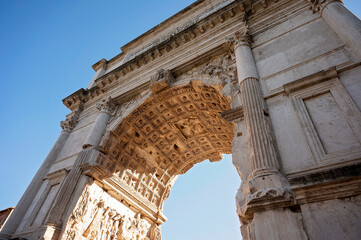 Low-angle view of a detailed ancient Roman triumphal arch
