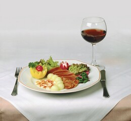 Plate with food and glass of wine