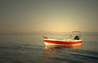Motorboat anchored in the sea at Agia Galini, Crete, Greece, Europe