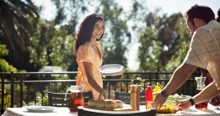 Woman, friends and food at party for social, gathering and outdoor New Years celebration. Girl, happy and serving lunch at event venue for reunion, sharing meal and bonding at table in holiday season