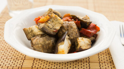 Dish of vegetable stew. stewed eggplant, minced meat, carrots, peppers, onion squid