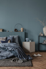 A harmonious arrangement of soft bedding in shades of blue, paired with decorative pillows and...