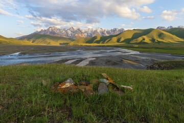 River coming from Köl-Suu mountain range at sunset, Kurumduk valley, Naryn province, Kyrgyzstan,...
