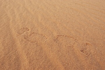Two opposite footprints in sand