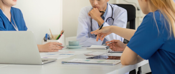 Diverse healthcare professionals discussing patient care strategies in a team meeting.