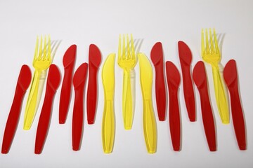 Red and yellow plastic cutlery, plastic knives, plastic forks, plastic waste, Germany, Europe