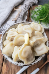 Siberian dumplings boiled with butter. Dumplings in traditional clay dishes