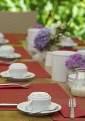 Table set for a celebration in the outdoor area of a restaurant in portrait format