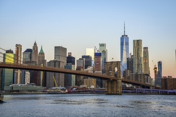 Brooklyn Bridge at sunrise, view from Main Street Park over the East River to the skyline of Manhattan with Freedom Tower or One World Trade Center, Dumbo, Downtown Brooklyn, Brooklyn, New York