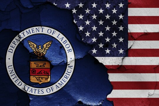 Flags of Department of Labor and USA painted on cracked wall