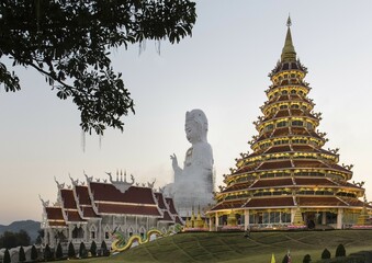 Illuminated Wat Huay Pla Kang temple at dusk with gigantic Guan Yin statue, Kuan Yin, Chiang Rai...