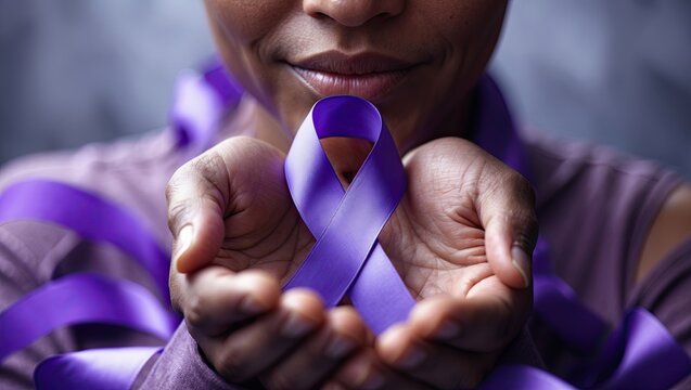 Rich purple ribbon in the hands with soft focus background