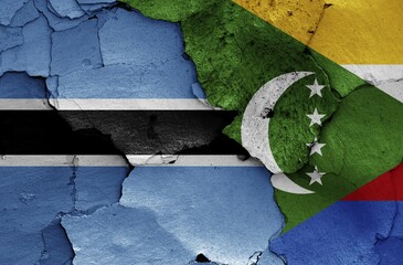 Flags of Botswana and Comoros painted on cracked wall