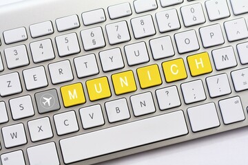 MUNICH writing on white keyboard with a aircraft sketch