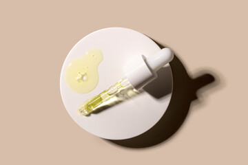  serum tests glass pipettes with drops of serum on a light beige background