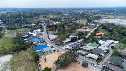 Obraz premium Aerial View of Suburban Neighborhood with Diverse Architecture in Northern Thailand