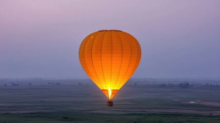Obraz premium Orange Hot Air Balloon Ascending at Dawn