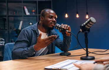 Black man is doing podcast in the studio