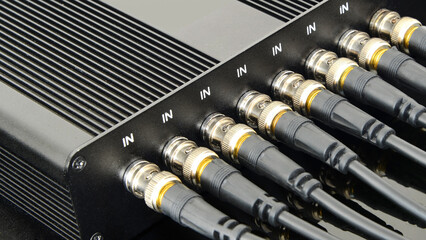 Connecting multiple devices using BNC connectors for secure audio and video transmission.