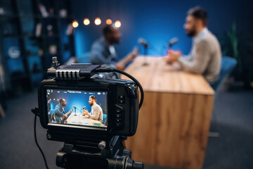 Interviewing the musician. Two radio presenters recording an audio broadcast in a studio