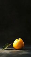 Ripe yellow quince with leaf on dark background.