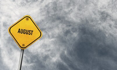 August, yellow sign with cloudy sky