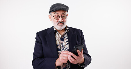 Cellphone, glasses and senior man in studio, internet and mobile app on white background. Email notification, model and mature person with smartphone, communication and eyewear for message to contact