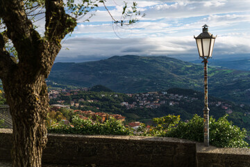 View of rolling hills and a vintage streetlamp in a picturesque landscape, San Marino