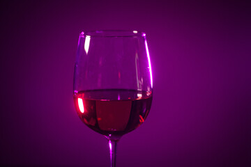 glass of pink wine on a colored background.