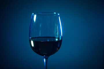 glass of pink wine on a colored background.