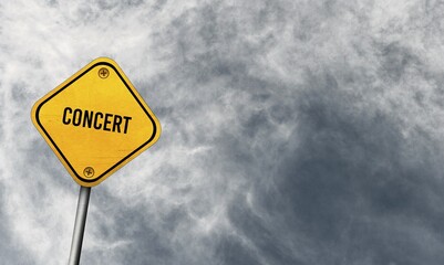 Concert, yellow sign with cloudy sky