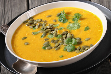 Pumpkin Red Lentil Soup in white bowl, top view