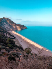 A pristine beach bathed in sunlight and surrounded by cliffs. Concept of paradise, serenity, and the natural beauty of coastal landscapes.