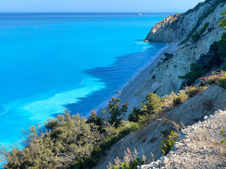 The untouched shoreline stretches beneath the cliffs, kissed by the sea. The concept of solitude, relaxation, and the harmony of nature and water