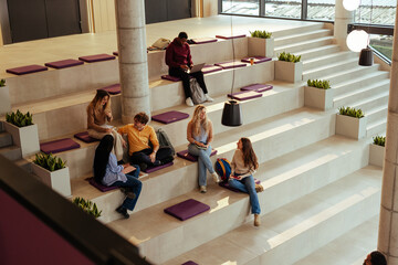 University students relaxing and studying in modern bleacher seating area