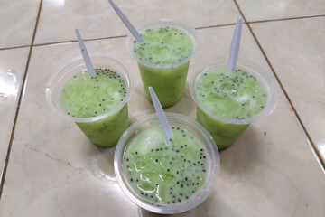 Melon iced in a plastic glass on the floor ready to eat