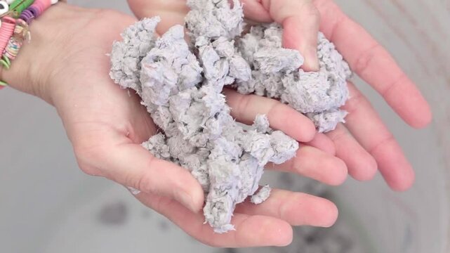 Hands touching wet paper for recycled handcraft