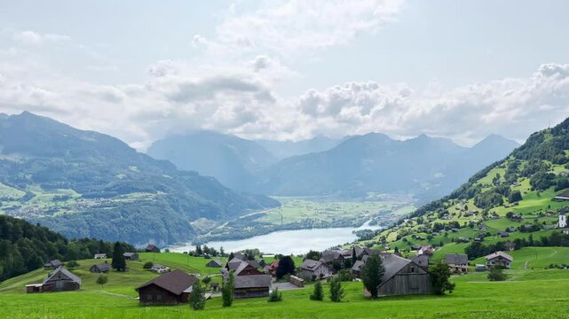 Very beautiful Swiss village mountain view green hills mountain lake, houses in the mountains
