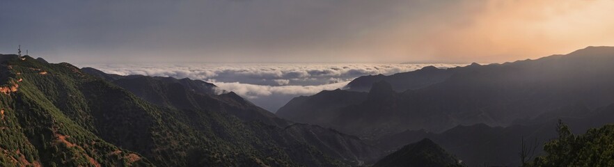 Naklejka premium Panorama, sunrise with trade wind clouds from the fertile valley of Vallehermoso, La Gomera, Canary Islands, Spain, Europe