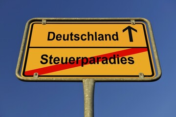 Obraz premium City limit sign, symbolic image for the way from a Steuerparadies to Deutschland, German for going from a tax haven to Germany