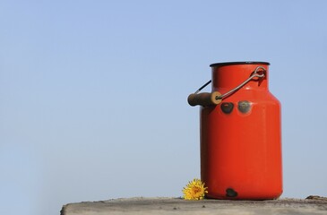 Old red milk can or churn