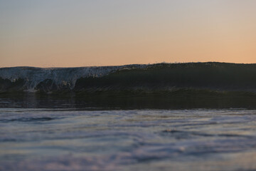 Fototapeta premium Wave breaking on the beach shore.