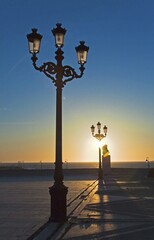 Obraz premium Lanterns in the evening sunlight, waterfront promenade in Cadiz, Andalusia, Spain, Europe