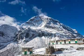 Majestic Snow-Capped Mountain with Traditional Structures
