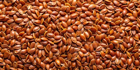Overhead shot: Brown flax seeds scattered on rustic linen, showcasing their texture.