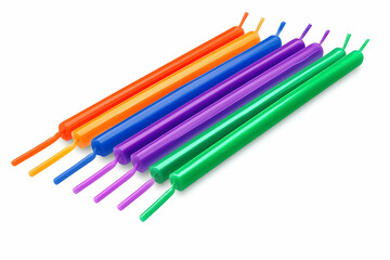 Fototapeta premium Colorful Candlesticks Arranged Neatly on a White Background, Ready for a Celebration