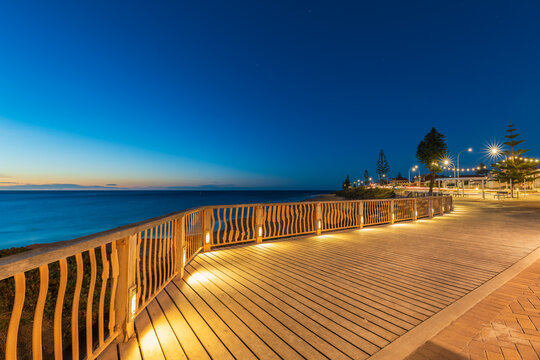 Christies Beach esplanade with Witton Bluff trail illuminated at night time while viewed towards the ocean