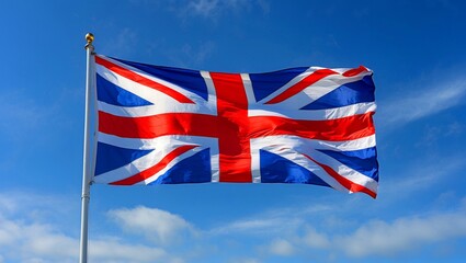 Union jack flag waving gracefully in blue sky